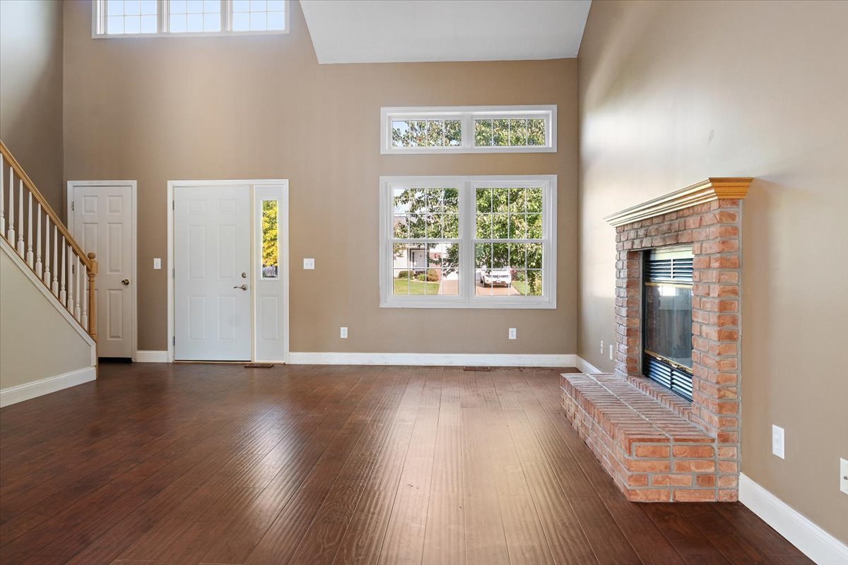 606 Windward Way Heyworth, IL 61745 - Photo 3 of 30 an empty room with wooden floor and windows