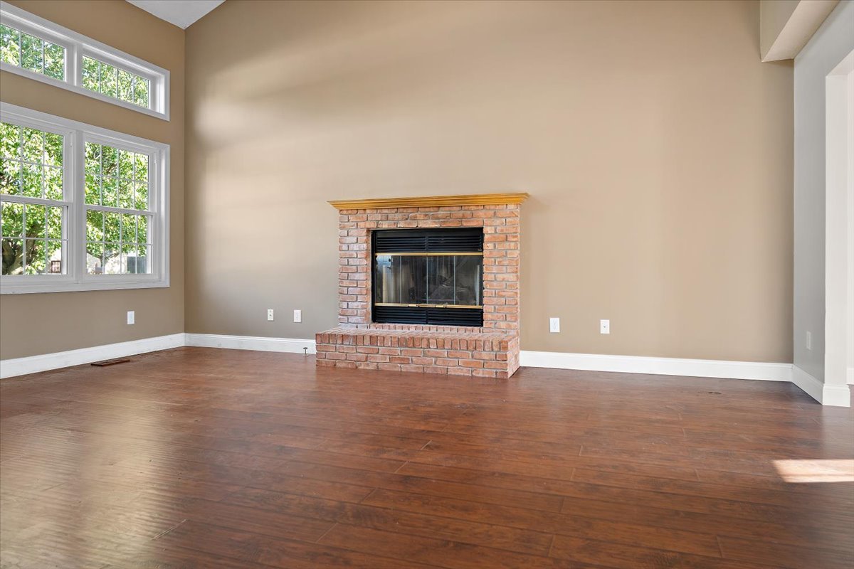 606 Windward Way Heyworth, IL 61745 - Photo 4 of 30 an empty room with wooden floor and windows