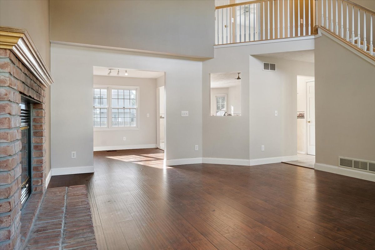 606 Windward Way Heyworth, IL 61745 - Photo 5 of 30 an empty room with wooden floor and windows