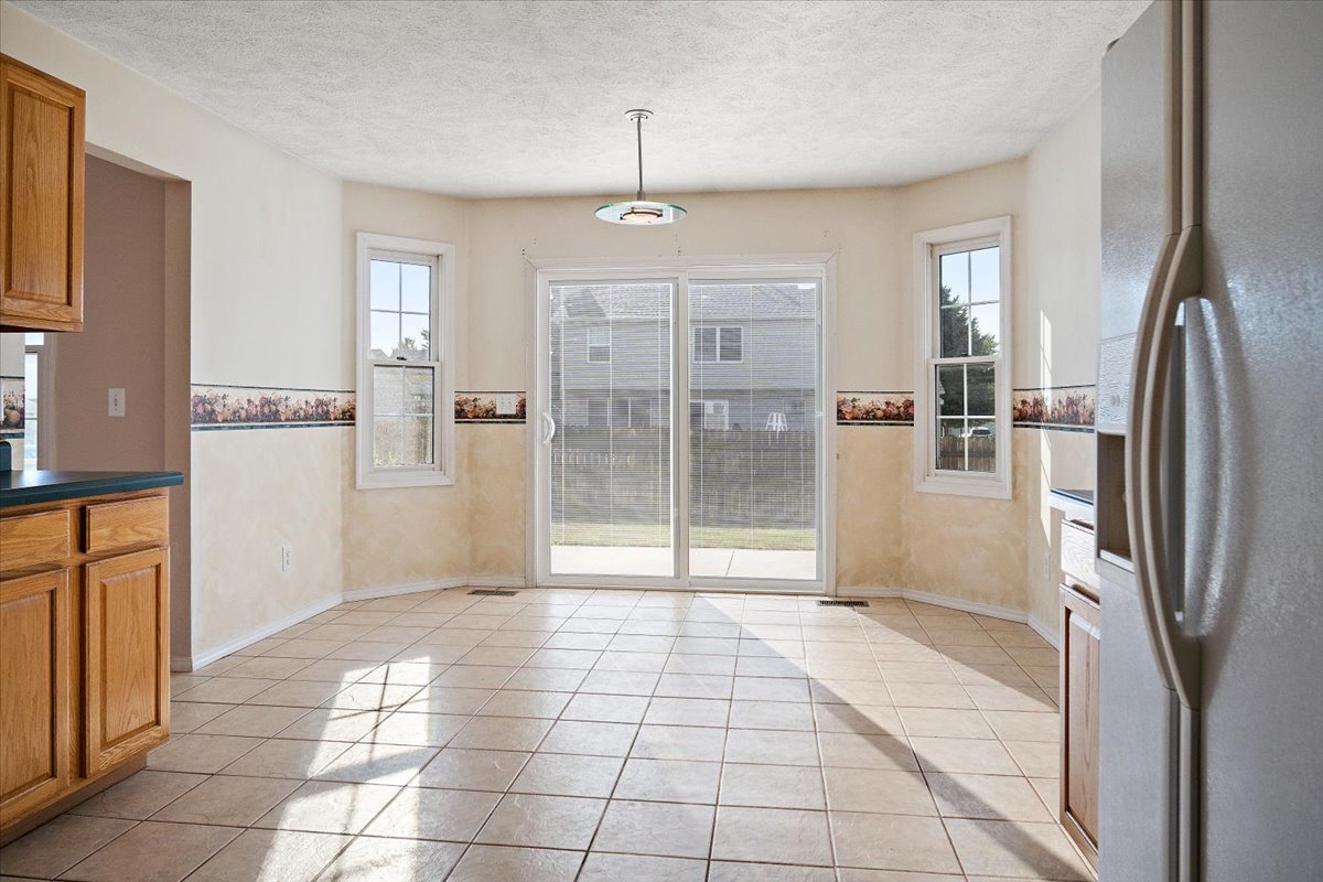 606 Windward Way Heyworth, IL 61745 - Photo 8 of 30 a view of a kitchen with a refrigerator and a sink
