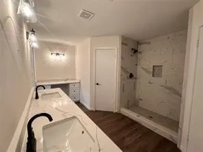 a bathroom with a granite countertop sink