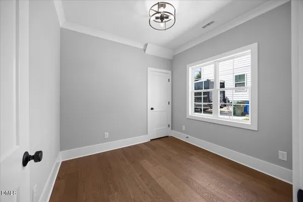 a kitchen with stainless steel appliances kitchen island granite countertop a refrigerator a sink dishwasher a stove and white countertops with wooden floor