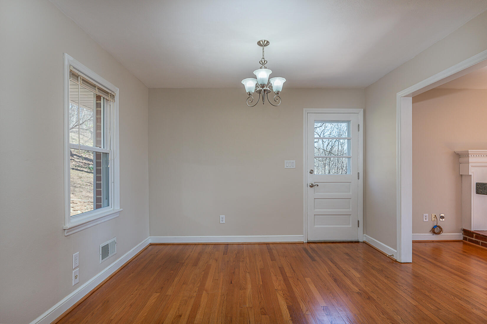 724 Eddies Road Salem, VA 24153 - Photo 13 of 54 an empty room with wooden floor chandelier and windows