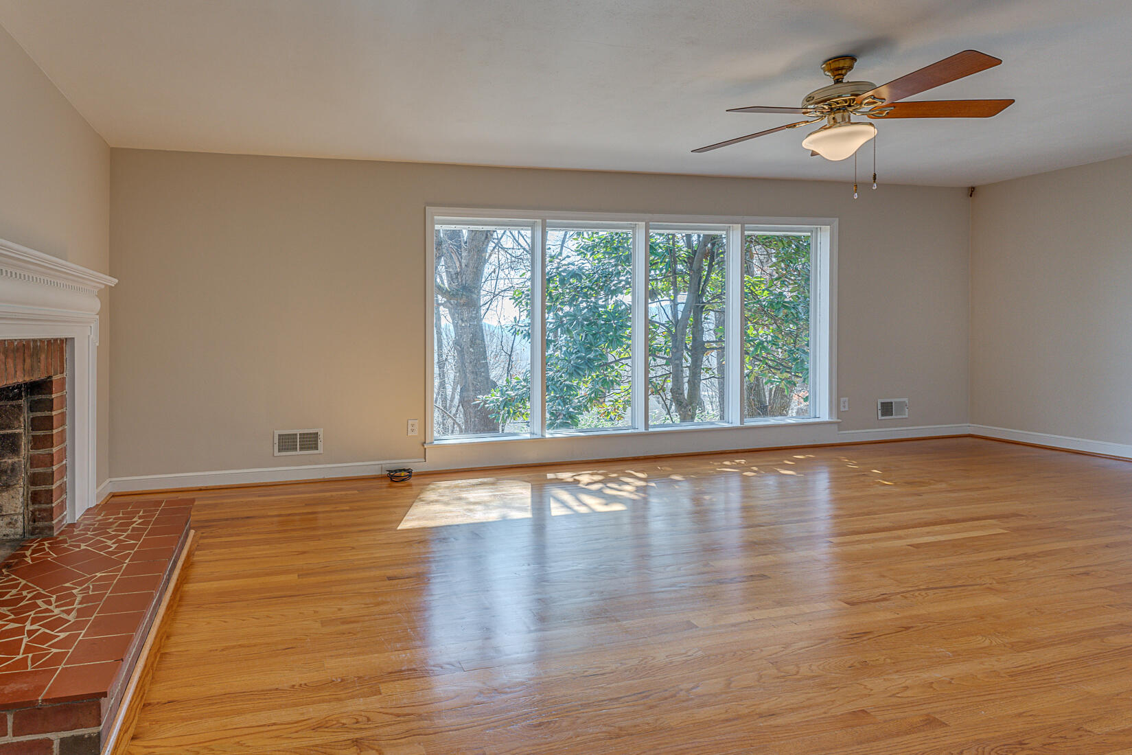 724 Eddies Road Salem, VA 24153 - Photo 16 of 54 a view of an empty room with window and wooden floor