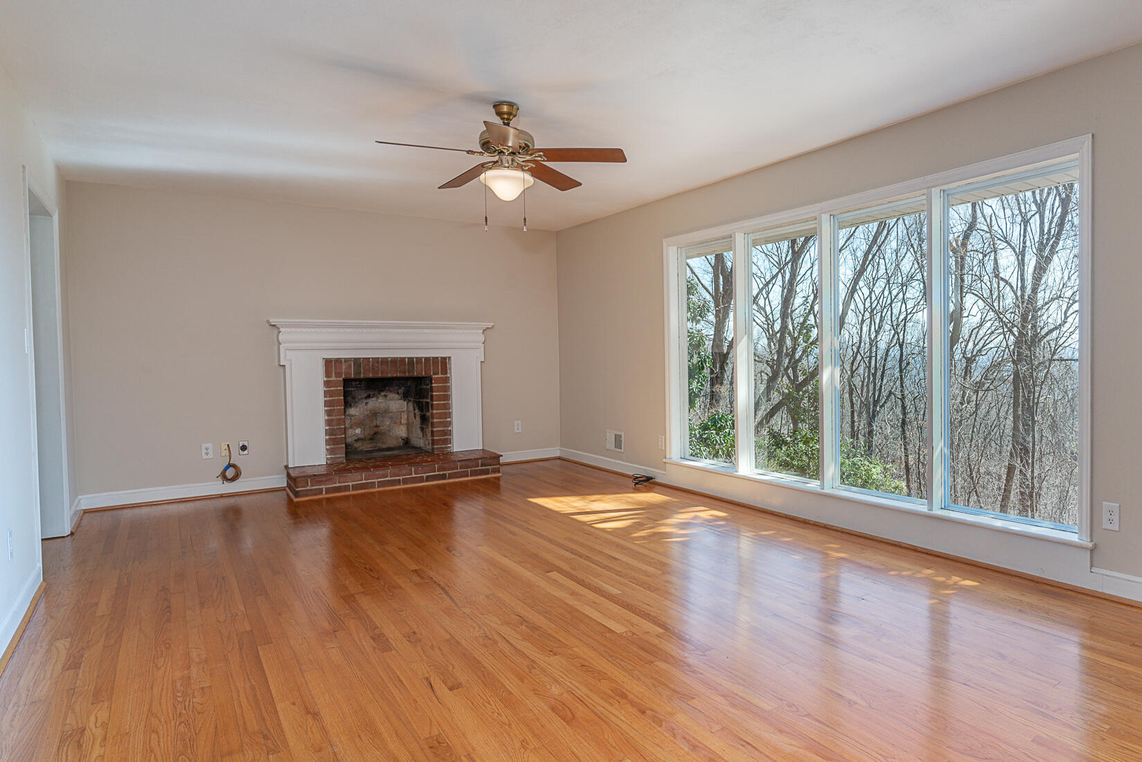 724 Eddies Road Salem, VA 24153 - Photo 17 of 54 a view of an empty room with wooden floor and a window