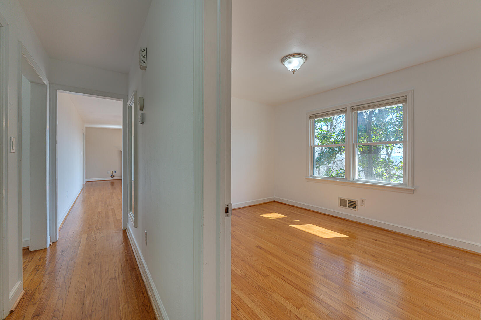 724 Eddies Road Salem, VA 24153 - Photo 21 of 54 a view of an empty room with wooden floor and a window