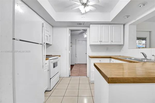 a kitchen with a refrigerator a sink and cabinets