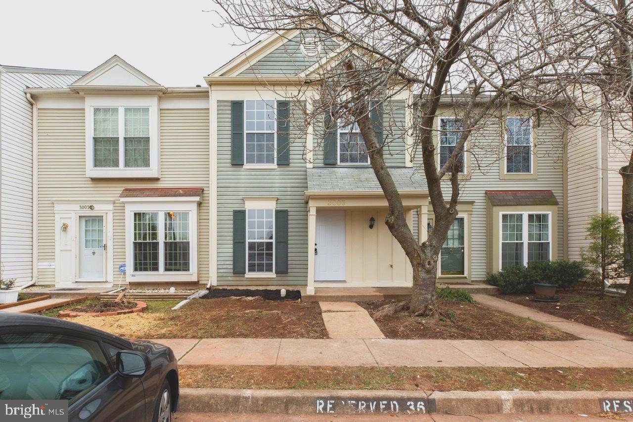 a front view of a house with a yard and a garage