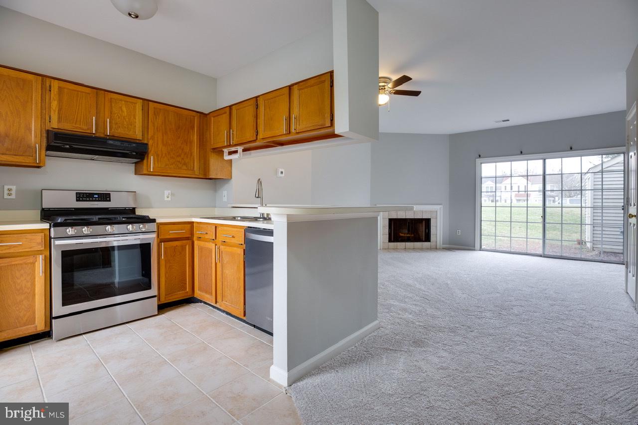 3005 McMaster Court Herndon, VA 20171 - Photo 16 of 26 a kitchen with stainless steel appliances a stove a sink and a microwave