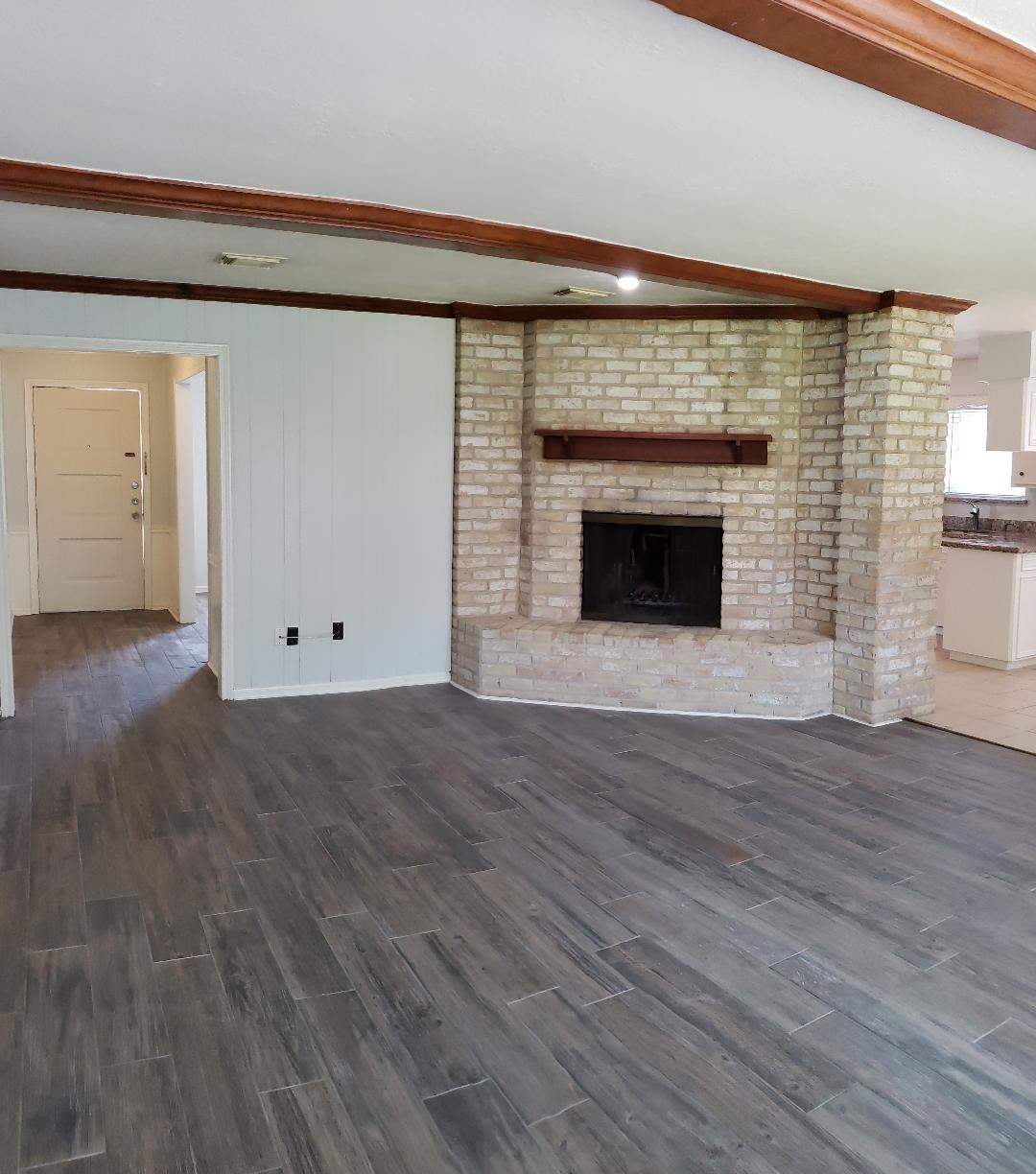 12314 Rincon Drive Houston, TX 77077 - Photo 10 of 36 Large Family room with fireplace and new flooring.