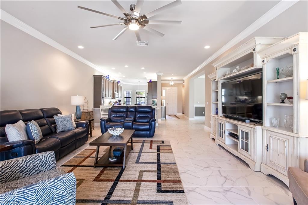4310 Aurora Street Naples, FL 34119 - Photo 1 of 17 a living room with furniture and a flat screen tv