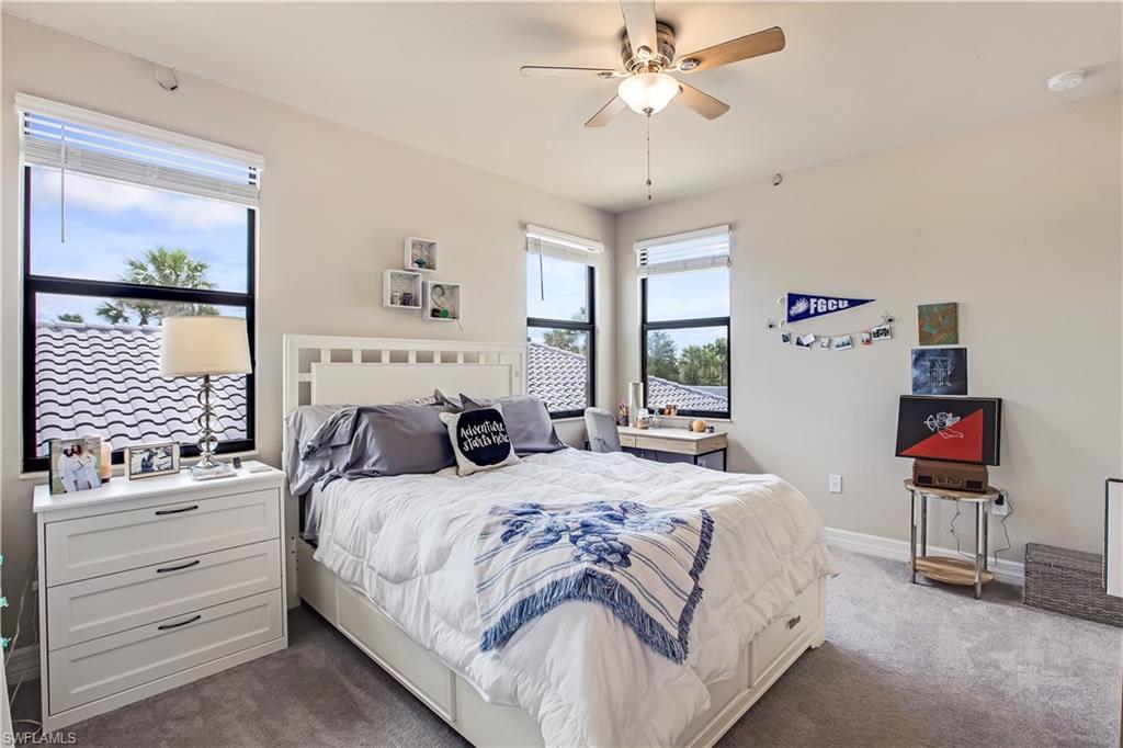 4310 Aurora Street Naples, FL 34119 - Photo 11 of 17 a bedroom with a bed and a chandelier