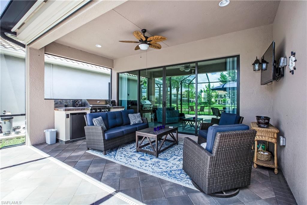 4310 Aurora Street Naples, FL 34119 - Photo 16 of 17 a living room with furniture and a flat screen tv