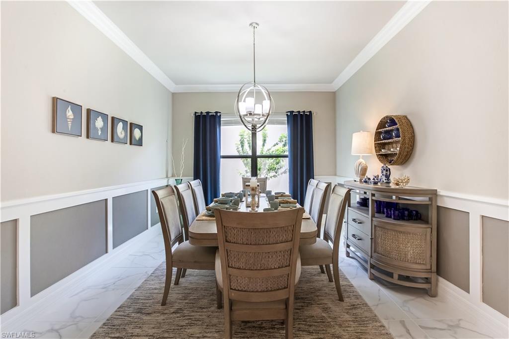 4310 Aurora Street Naples, FL 34119 - Photo 5 of 17 a dining room with furniture a chandelier and window