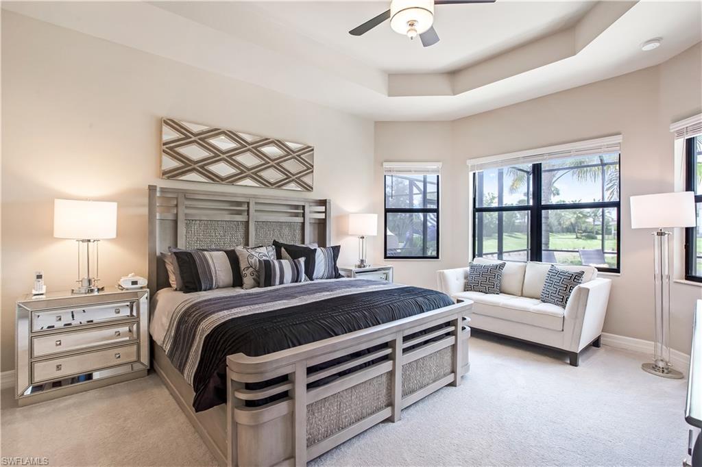 4310 Aurora Street Naples, FL 34119 - Photo 6 of 17 a bedroom with a bed a couch and a chandelier