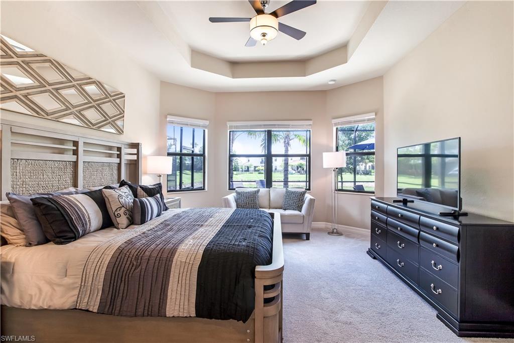 4310 Aurora Street Naples, FL 34119 - Photo 7 of 17 a bedroom with a bed a couch and a flat tv screen