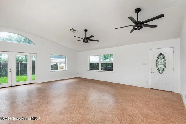 wooden floor in an empty room with a window