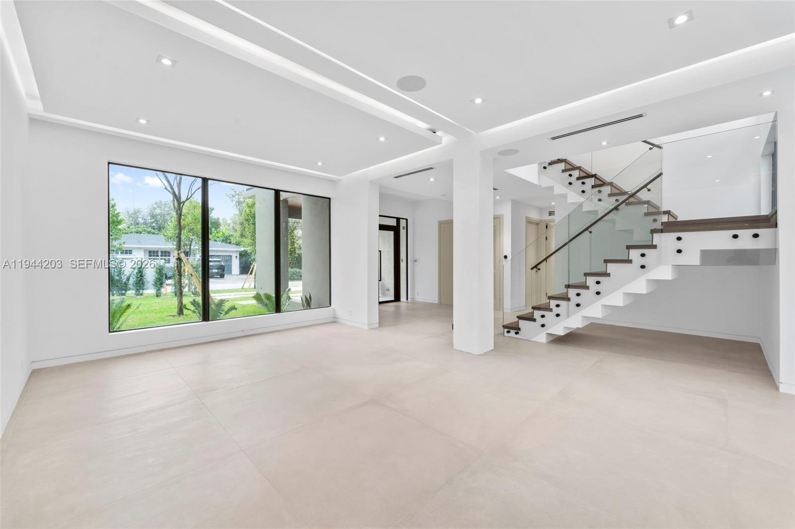 685 Northeast 81st Street Miami, FL 33138 - Photo 4 of 30 a view of an empty room with a large window and an entryway