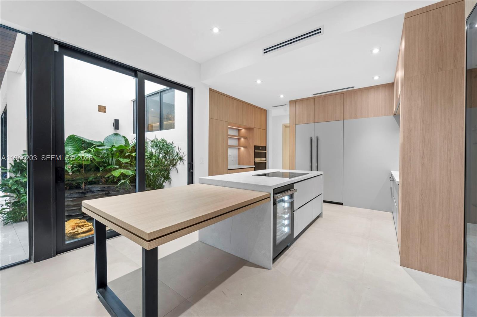 685 Northeast 81st Street Miami, FL 33138 - Photo 8 of 30 a kitchen with stainless steel appliances granite countertop a kitchen island a stove and a refrigerator