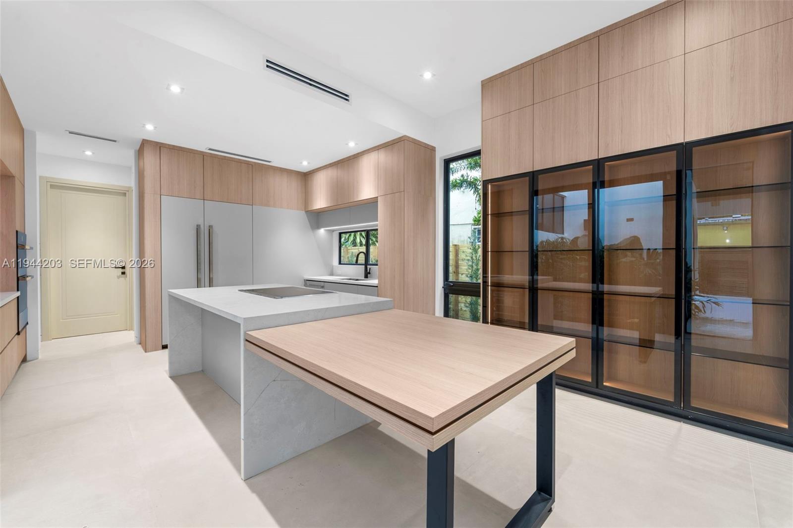 685 Northeast 81st Street Miami, FL 33138 - Photo 9 of 30 a kitchen with a refrigerator a sink and a large window