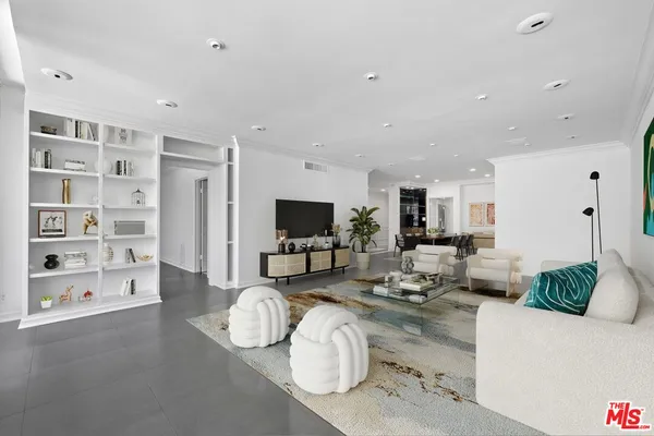 a view of an empty room with closet and racks
