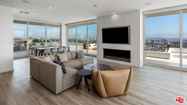 a living room with fireplace furniture and a flat screen tv