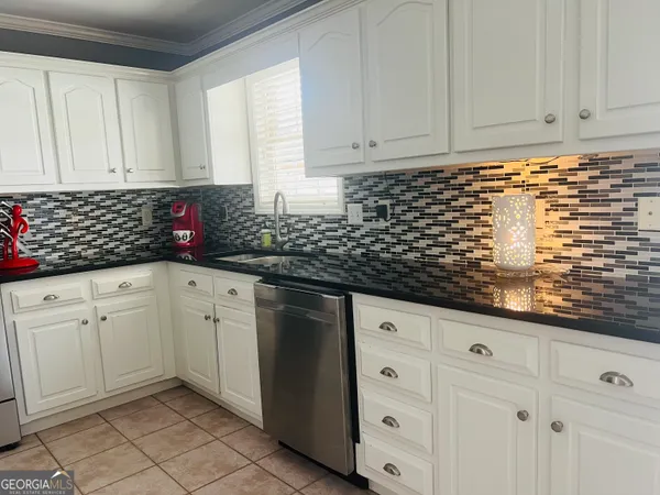 a kitchen with a stove and a refrigerator