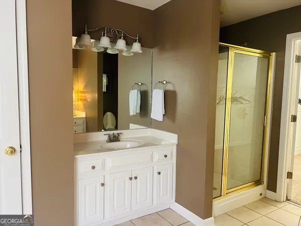 a bathroom with a sink a vanity and a mirror