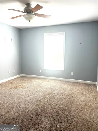 a room with a bed and a wall painting