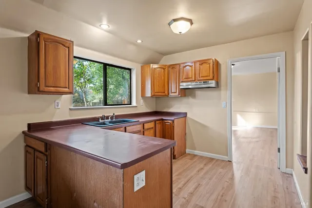 a kitchen with a refrigerator a sink and a window