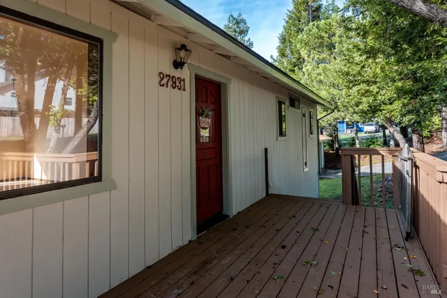 a view of backyard with a deck and wooden floor