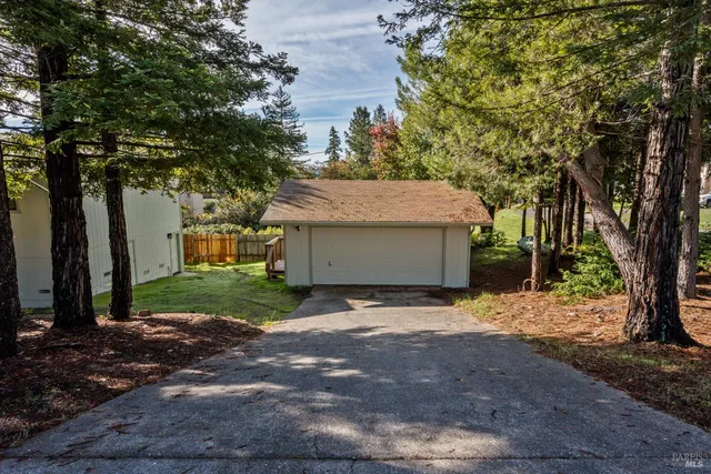 a view of a house with a tree and yard