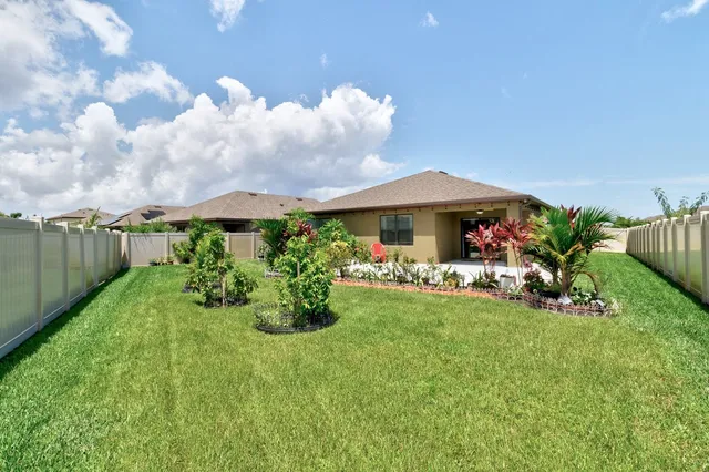 a view of a house with a yard and sitting area