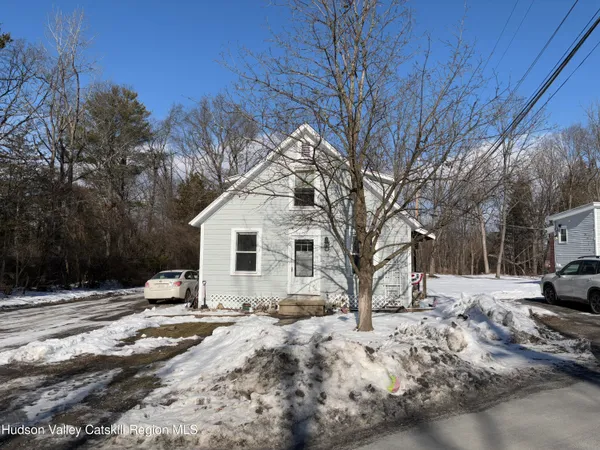 a view of a yard covered with snow in front of house