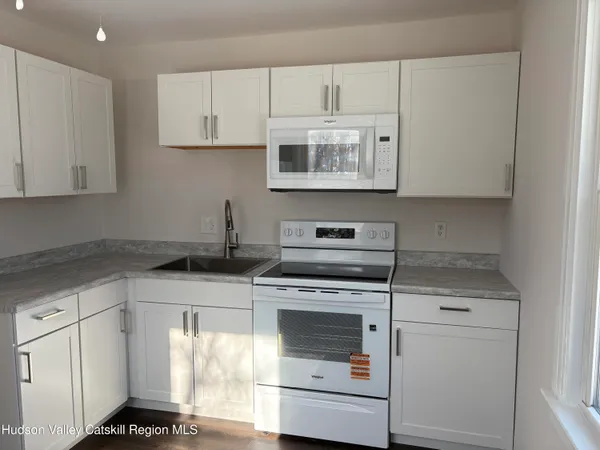 a kitchen with cabinets appliances and a sink