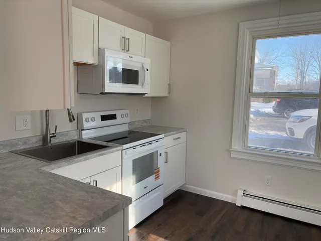 a kitchen with granite countertop a stove and a microwave