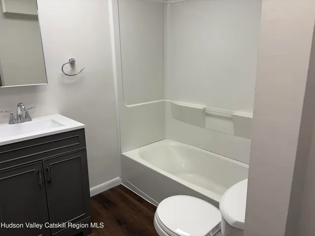 a white toilet sitting next to a bathroom sink