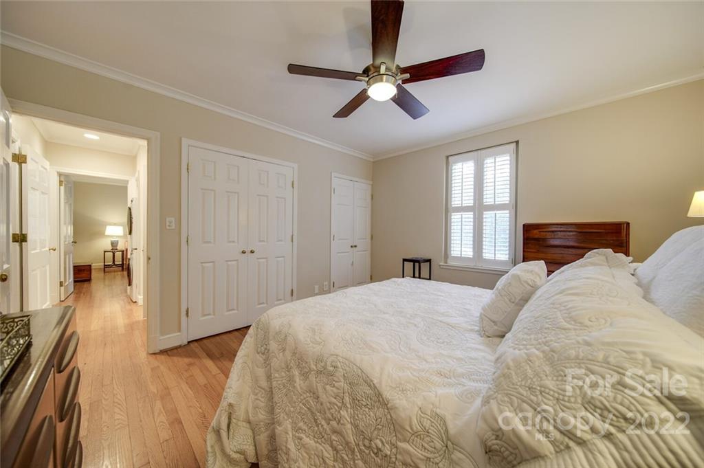 811 Queens Road, Unit 2 Charlotte, NC 28207 - Photo 15 of 31 a bedroom with a bed and a chandelier