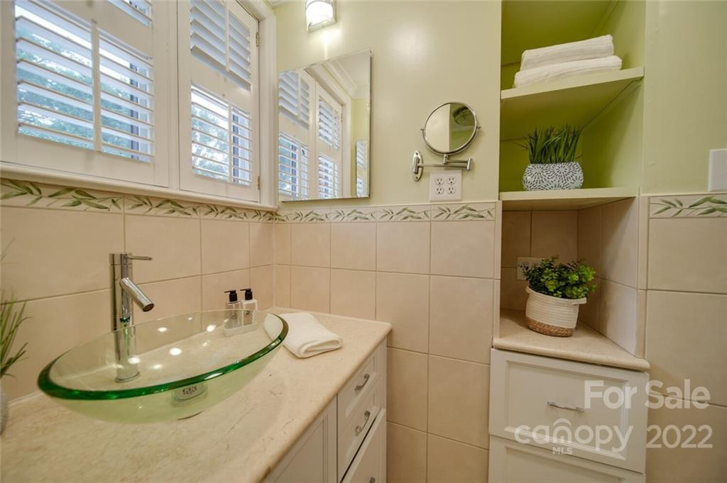 811 Queens Road, Unit 2 Charlotte, NC 28207 - Photo 18 of 31 a bathroom with a granite countertop sink and a mirror