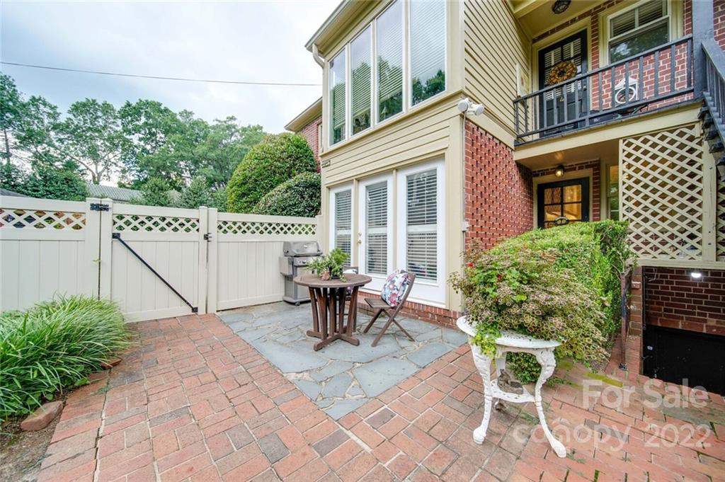 811 Queens Road, Unit 2 Charlotte, NC 28207 - Photo 23 of 31 a view of a patio with table and chairs and potted plants