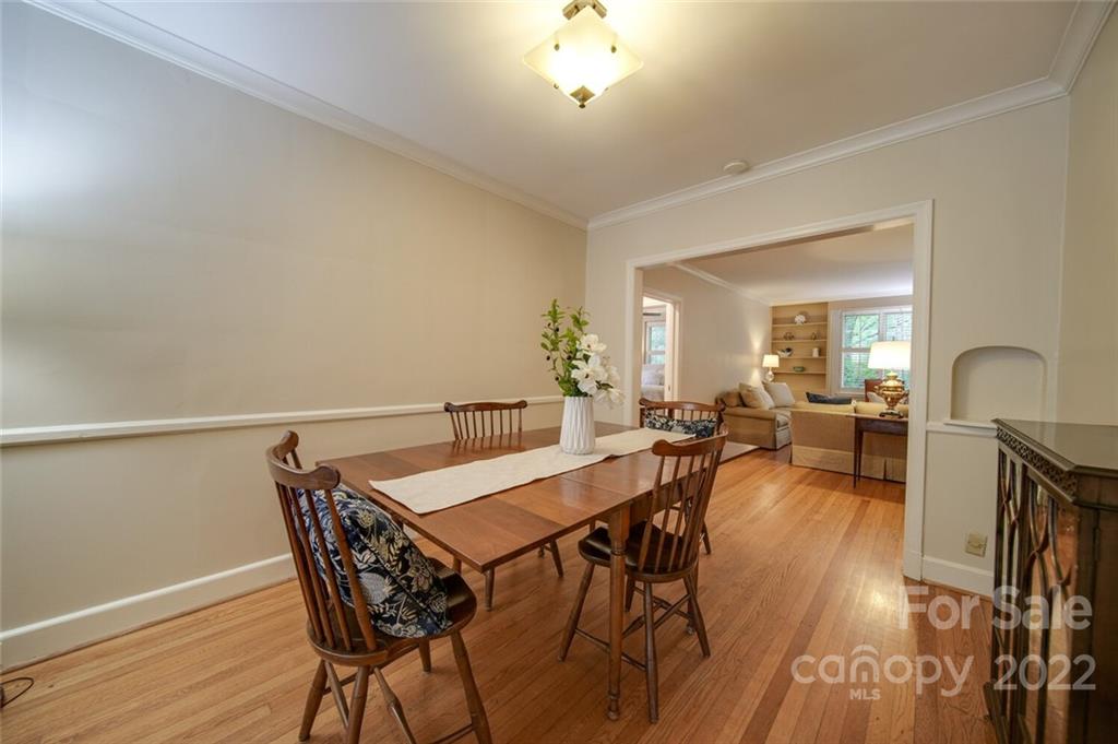 811 Queens Road, Unit 2 Charlotte, NC 28207 - Photo 5 of 31 a view of a dining room with furniture and a chandelier