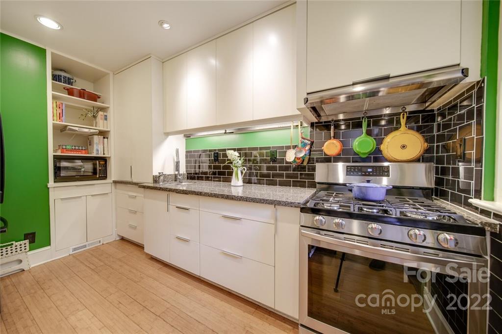 811 Queens Road, Unit 2 Charlotte, NC 28207 - Photo 7 of 31 a kitchen with stainless steel appliances granite countertop a stove and cabinets