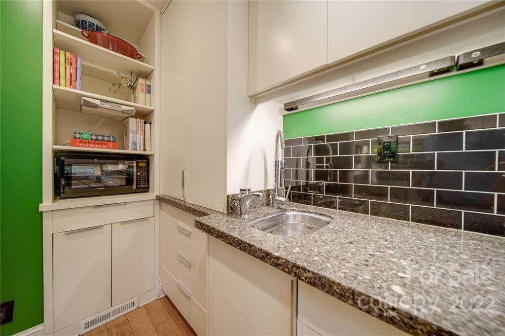 811 Queens Road, Unit 2 Charlotte, NC 28207 - Photo 10 of 31 a kitchen with granite countertop a sink a stove and cabinets