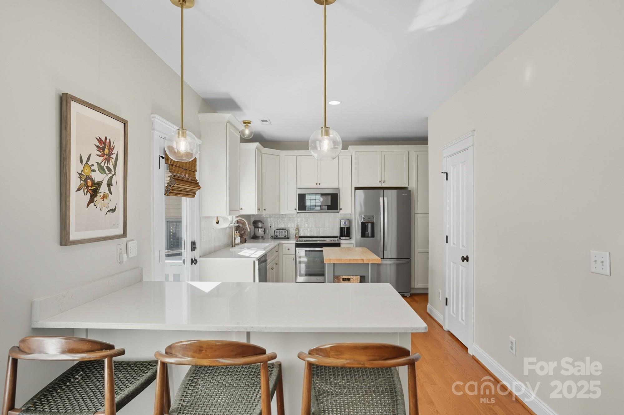 911 Cara Court Fort Mill, SC 29708 - Photo 16 of 48 a large kitchen with a table chairs and a refrigerator