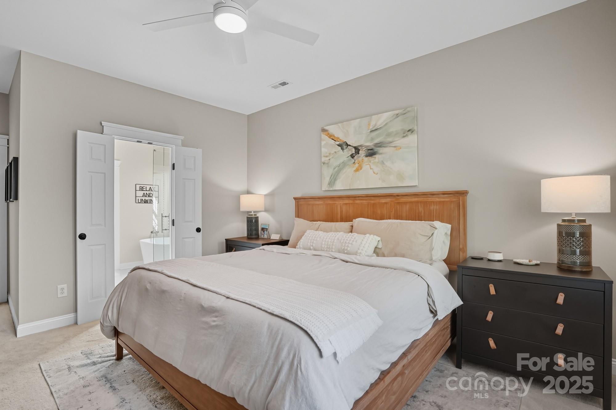 911 Cara Court Fort Mill, SC 29708 - Photo 25 of 48 a bedroom with a bed and a lamp on dresser