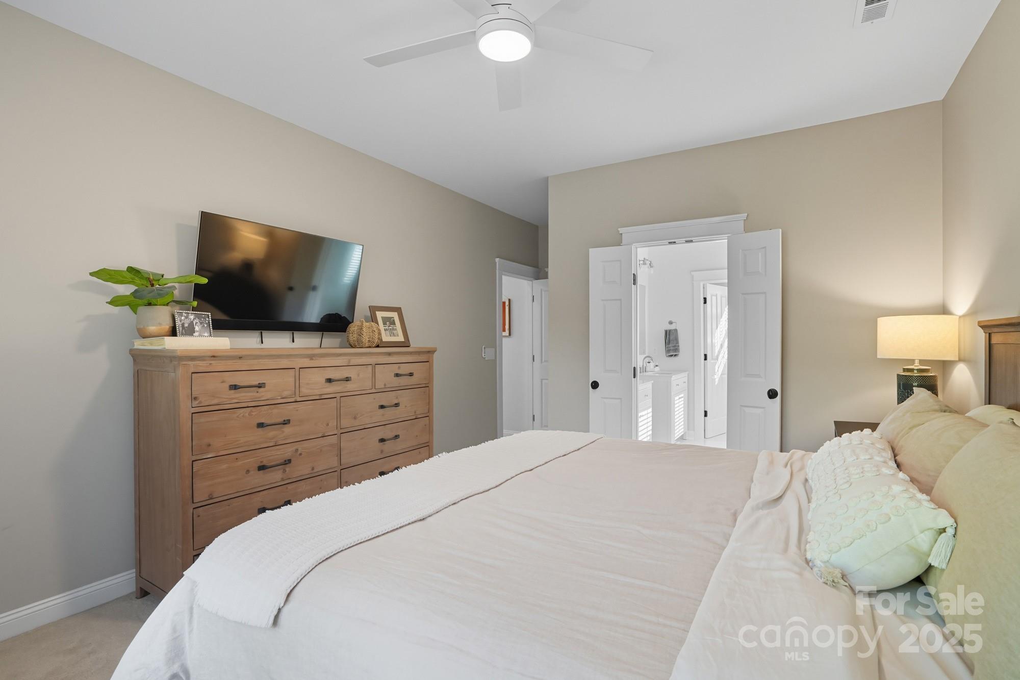 911 Cara Court Fort Mill, SC 29708 - Photo 26 of 48 a bedroom with a bed and a flat screen tv in it