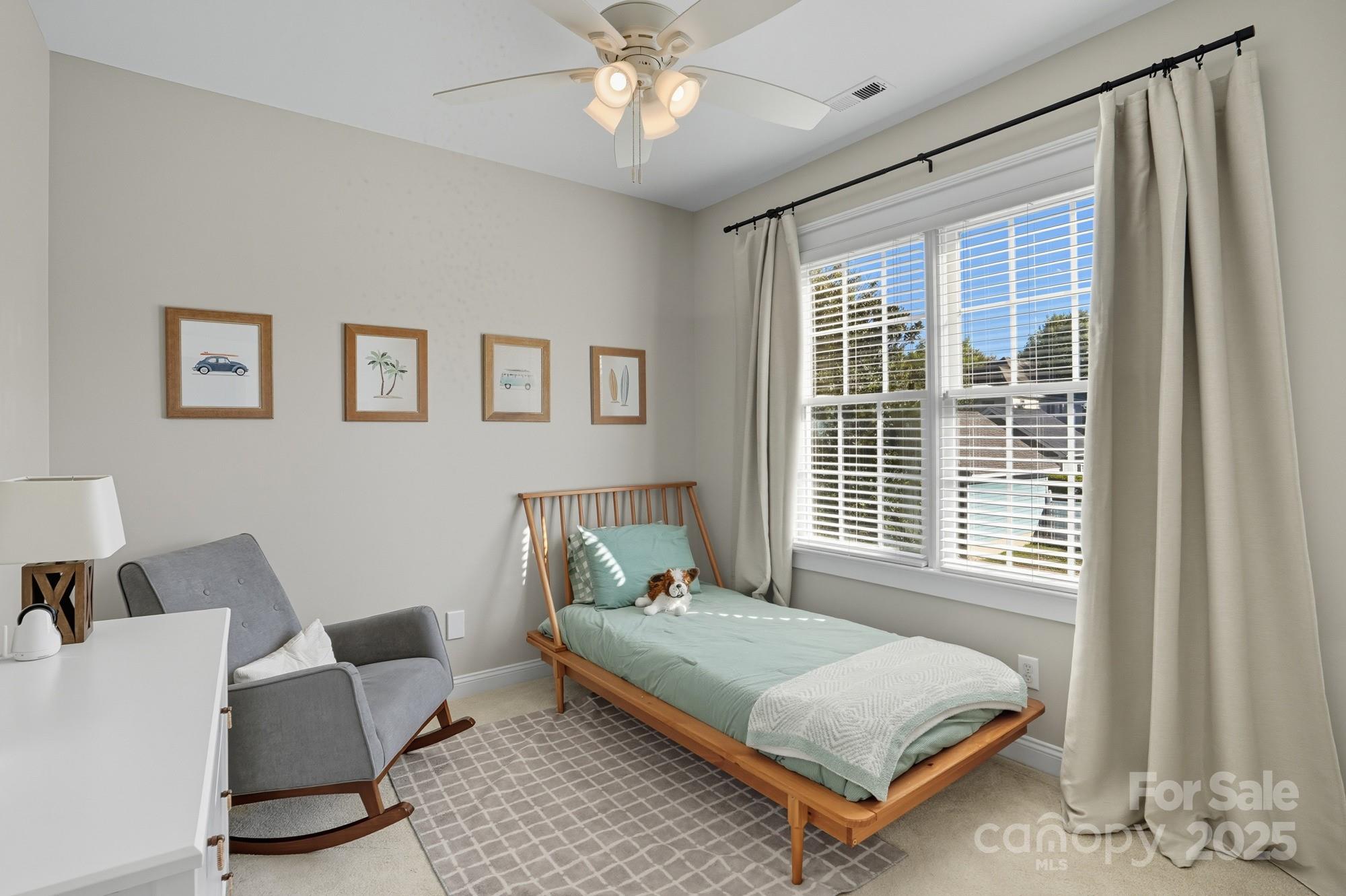 911 Cara Court Fort Mill, SC 29708 - Photo 31 of 48 a bedroom with a bed window and couch