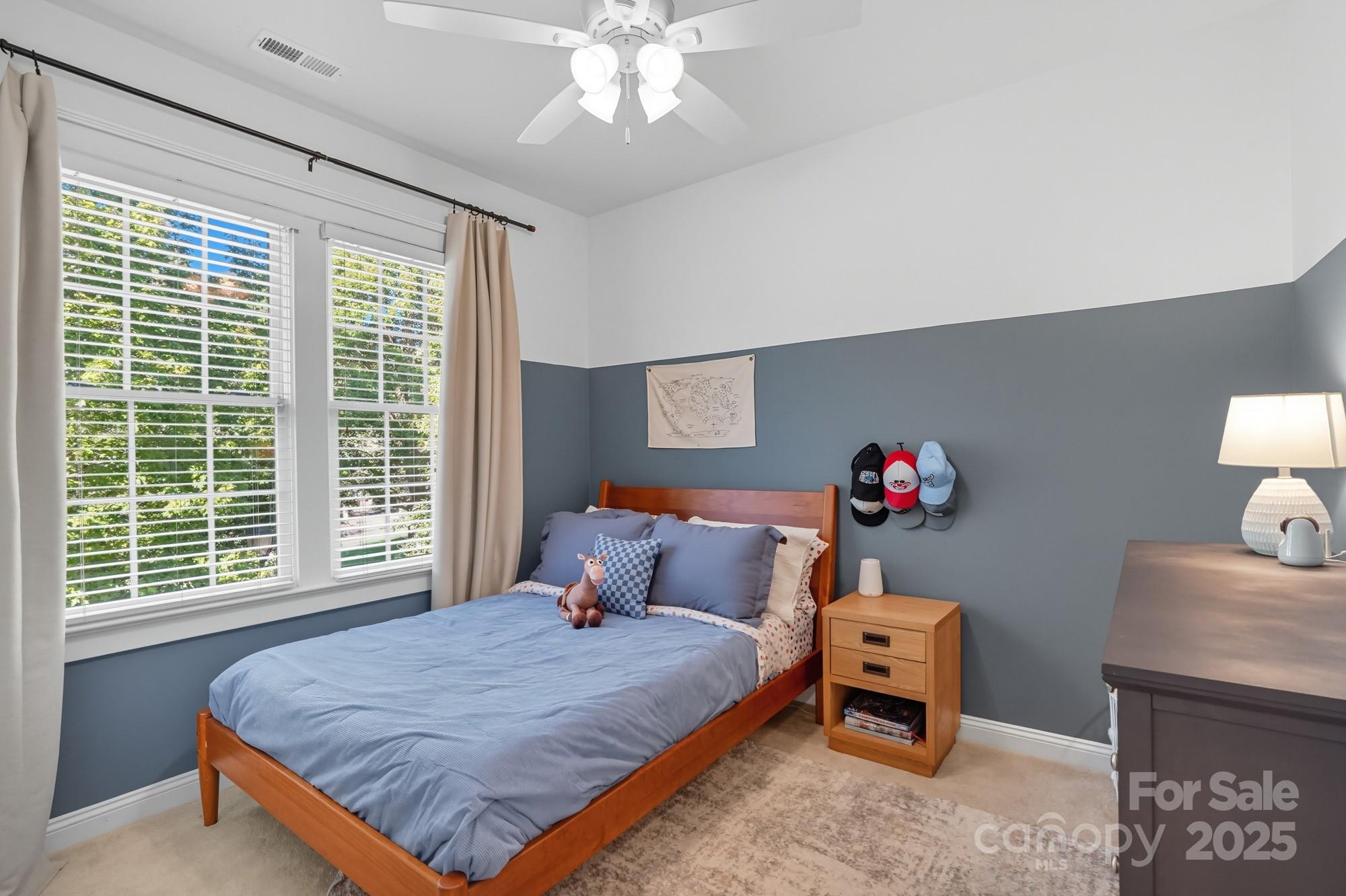 911 Cara Court Fort Mill, SC 29708 - Photo 34 of 48 a bedroom with a bed and a chandelier