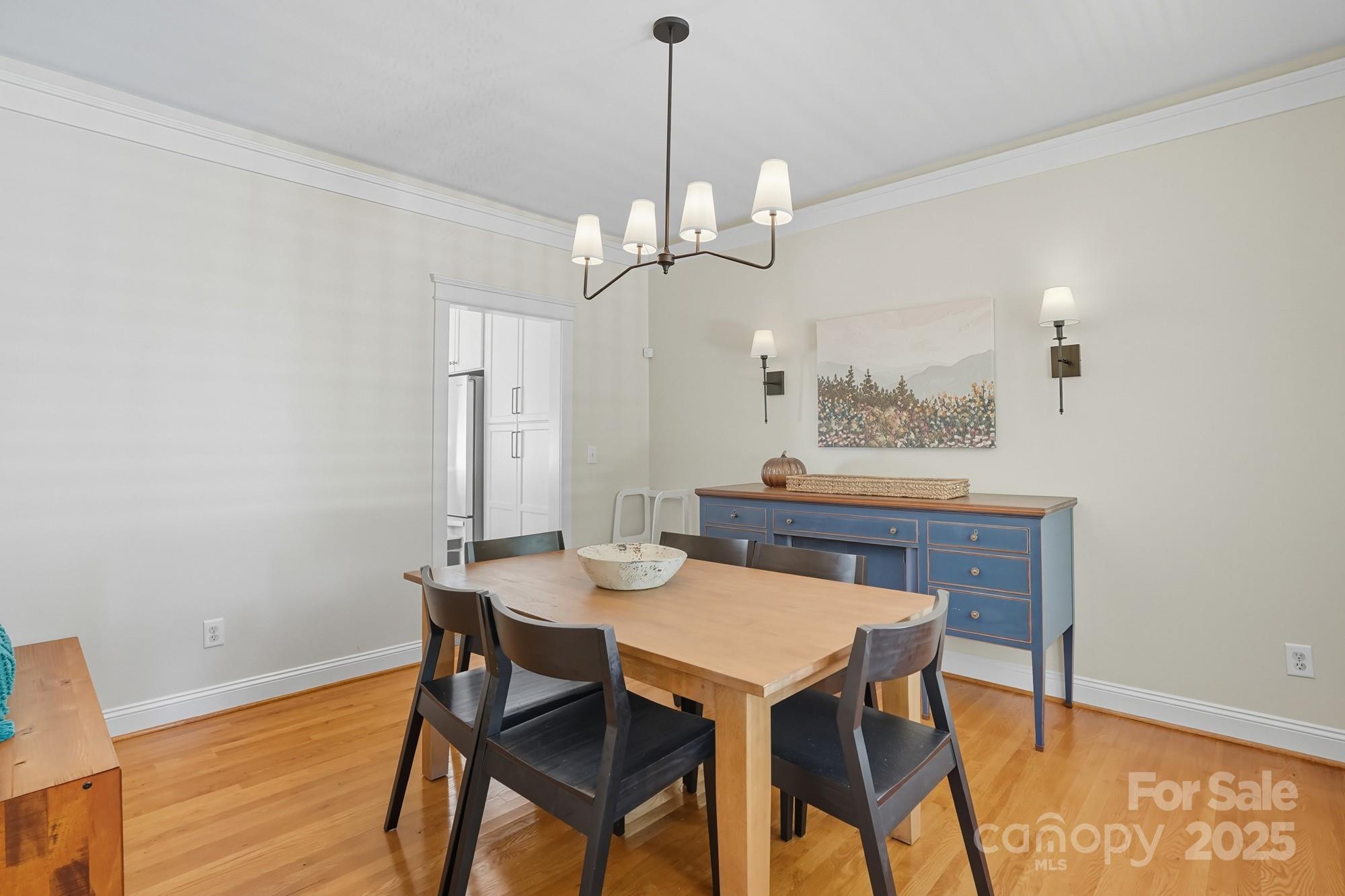 911 Cara Court Fort Mill, SC 29708 - Photo 7 of 48 a view of a dining room with furniture a chandelier and wooden floor
