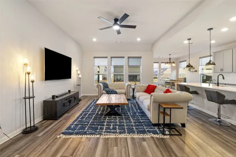 a living room with furniture and kitchen view